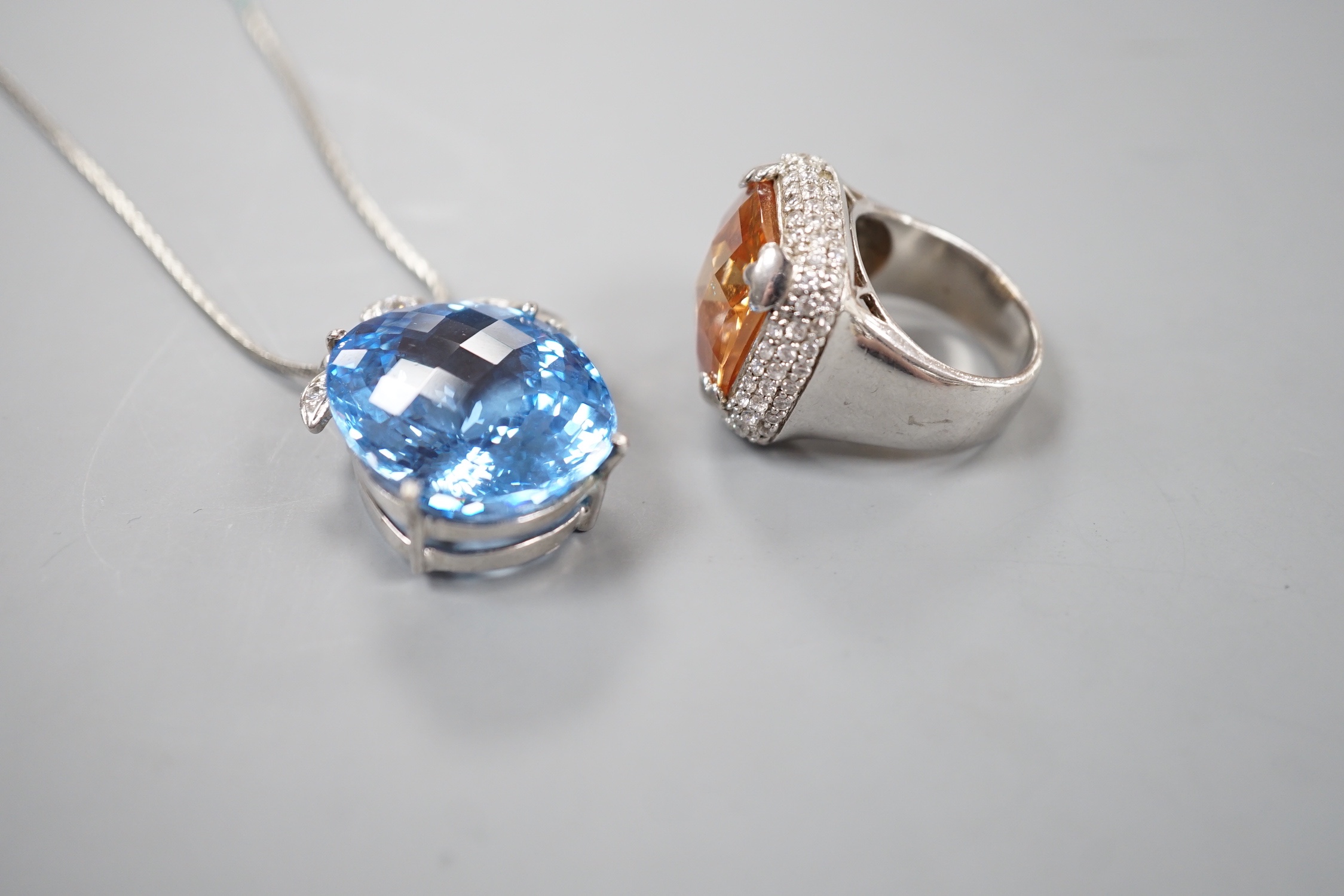 A modern 925 and paste set dress ring and a blue and white paste cluster set pendant on chain.